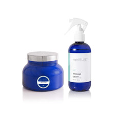 Capri Blue Volcano candle and spray bottle on a white background