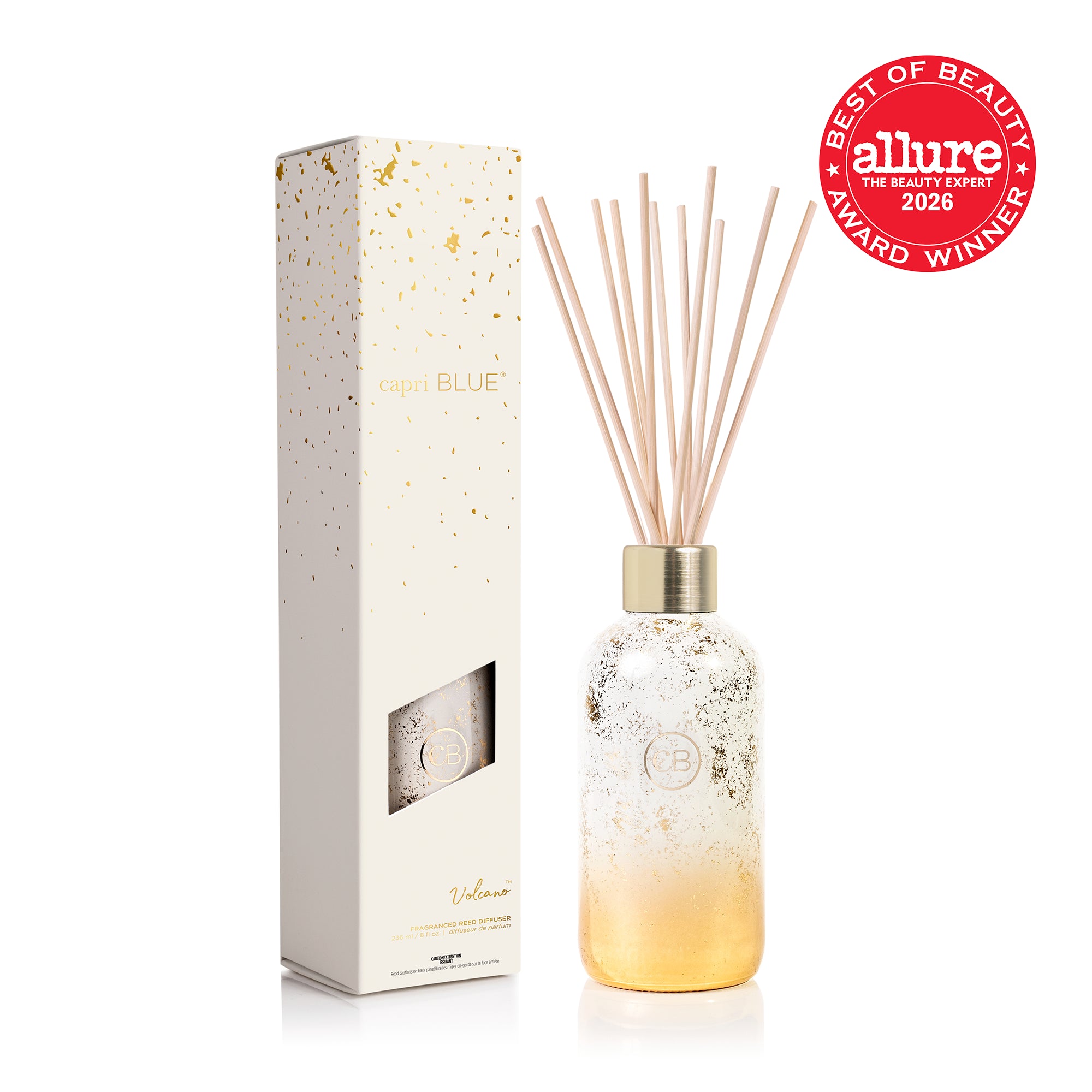 A yellow and white ombre diffuser bottle with metallic gold foil and natural wood reeds, shown next to its white and gold foil packaging box and the Allure 2026 Best of Beauty Award Winner seal.
