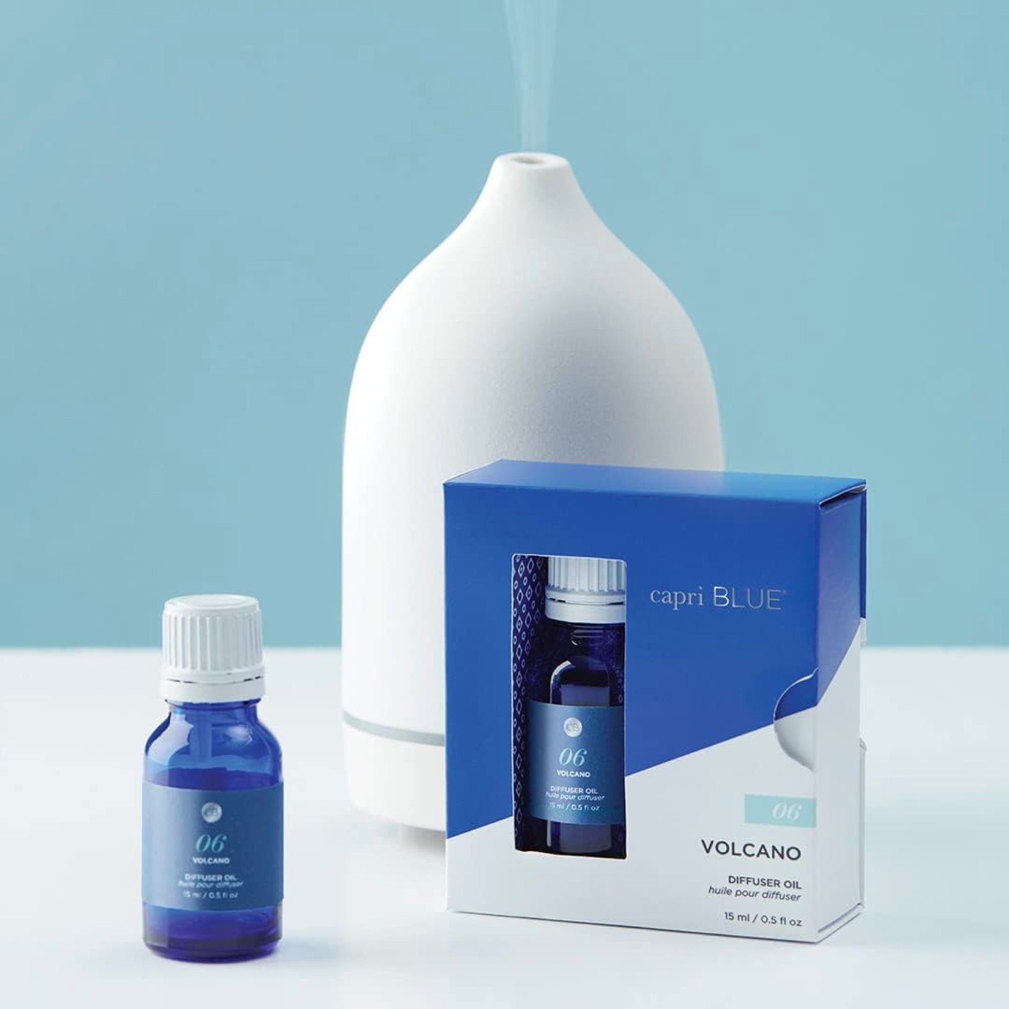 Capri Blue diffuser oil set with a white diffuser on a light blue background