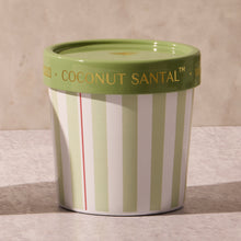 Green and white striped container with a green lid on a marble surface