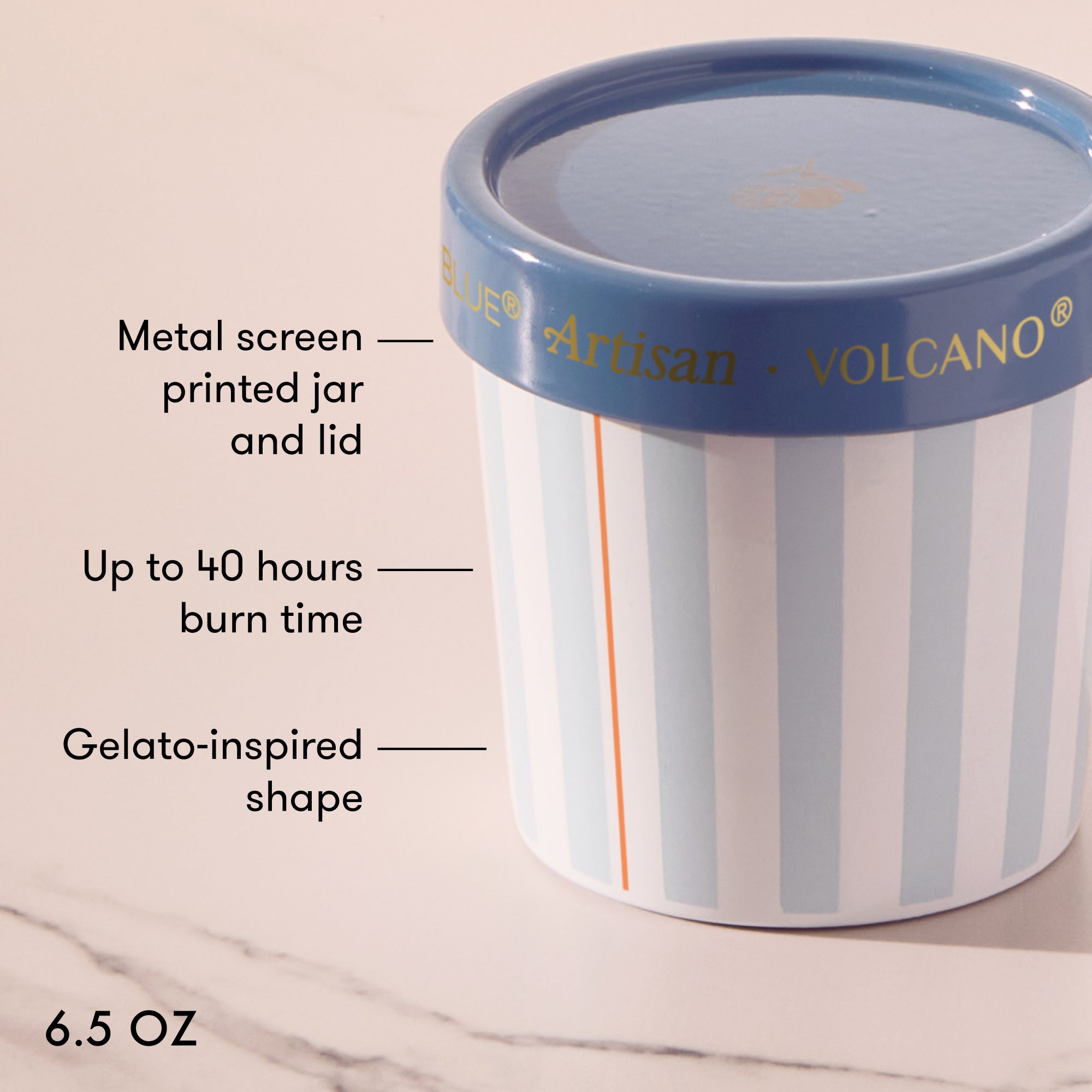 Candle jar with striped design and blue lid on a marble surface, featuring text about product features.