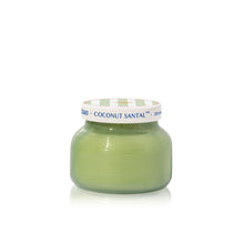 Green candle jar with a white lid on a white background