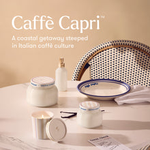 Caffè Capri products on a table with a chair and candle, set against a beige background.