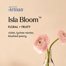capri BLUE Artisan Isla Bloom with pink flowers in a vase on a beige background.
