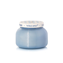 Blue candle jar with 'Volcano' branding on a white background