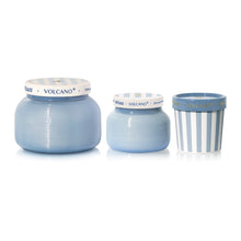 Three blue ceramic containers with white lids on a white background