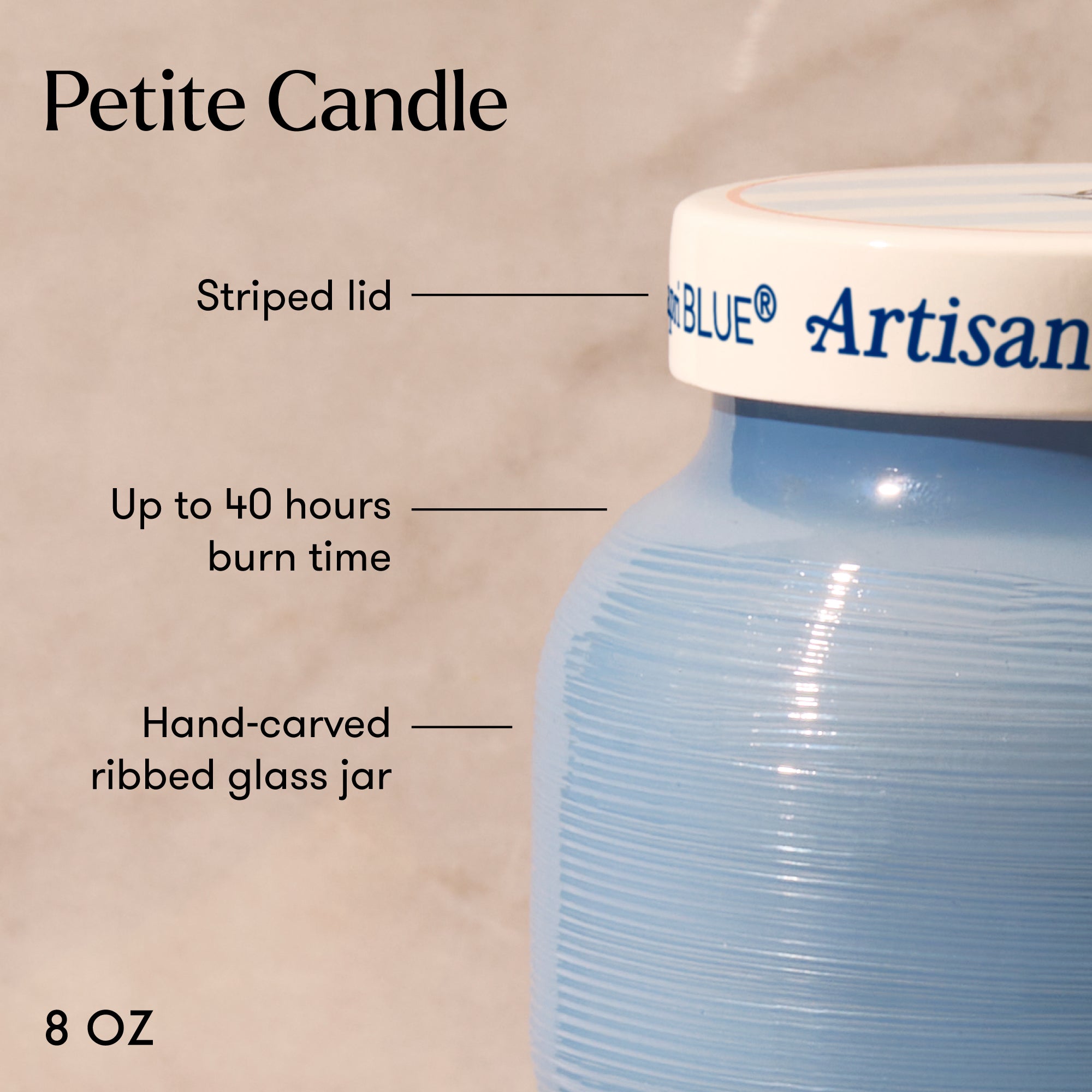 Blue candle jar with striped lid labeled 'Artisan Blue' on a beige background