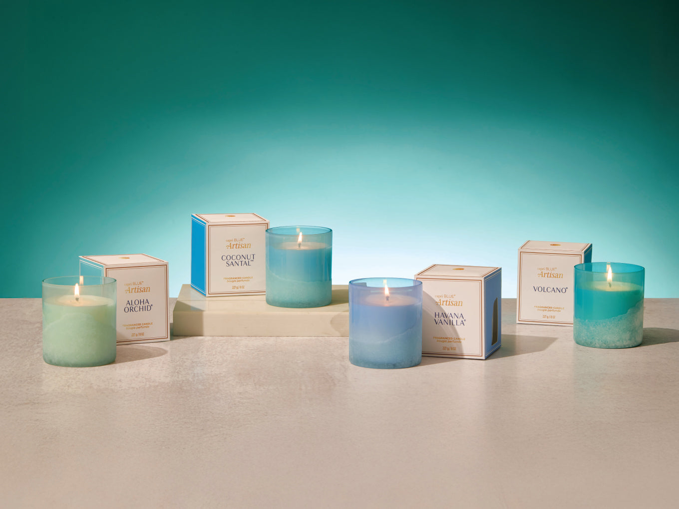 Set of candles and their packaging on a neutral background