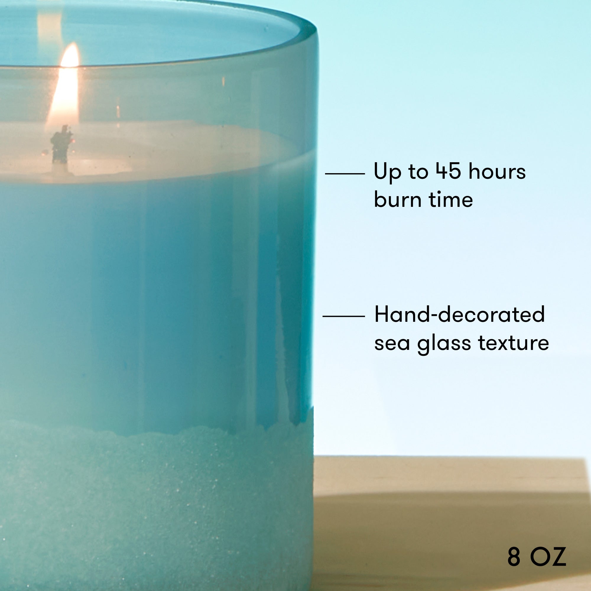 Blue glass candle with text indicating burn time and size