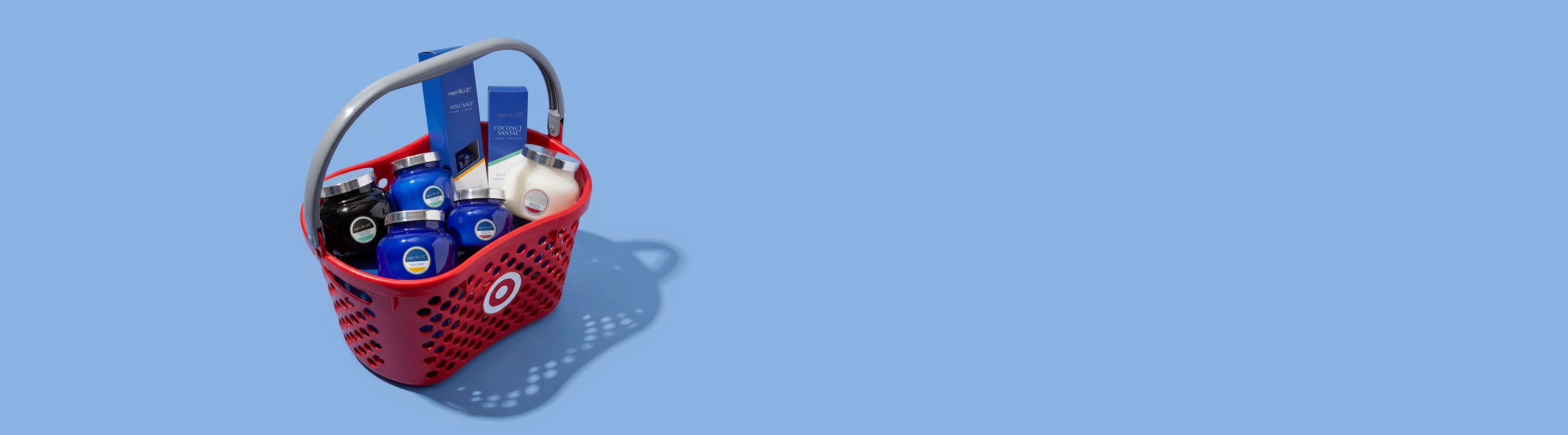 Red shopping basket with various items on a blue background