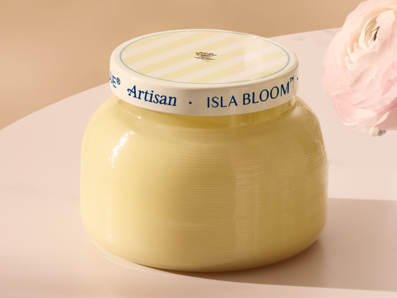 Jar of Isla Bloom Artisan cream on a beige background