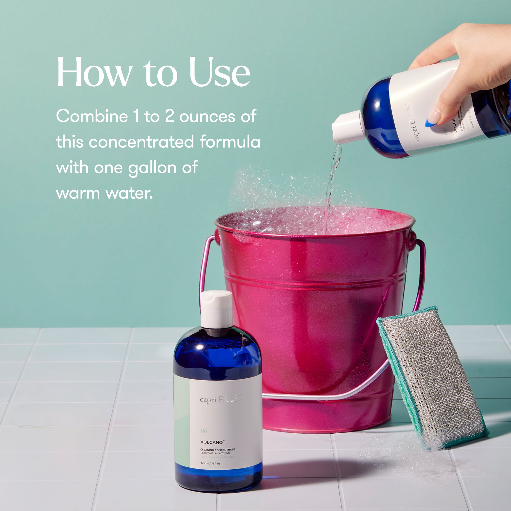 Bottle of concentrated formula being poured into a pink bucket with cleaning tools on a tiled floor.
