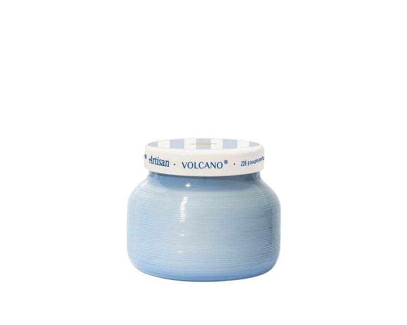 Blue candle jar with white lid on a white background