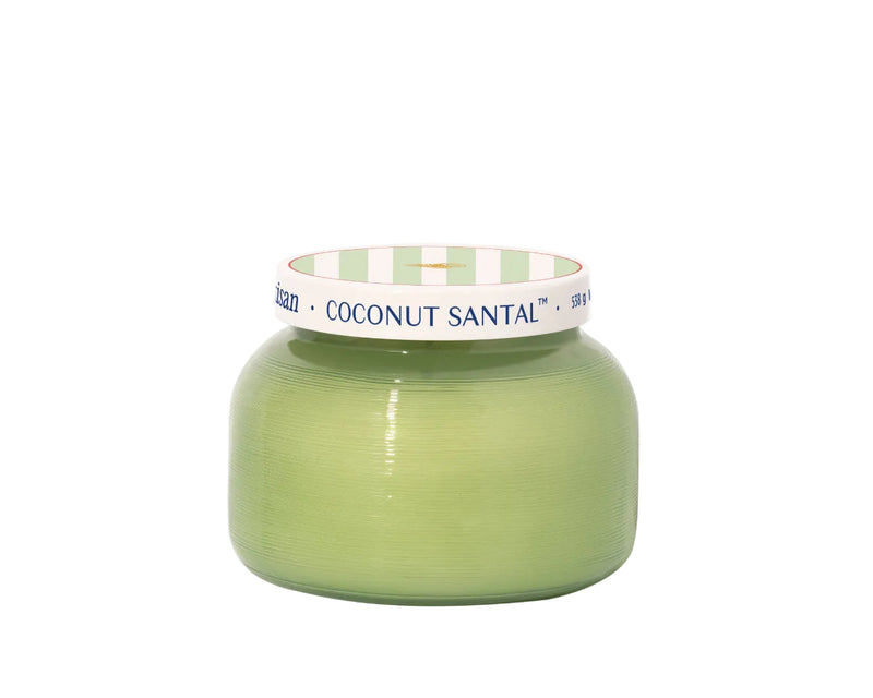 Green candle with a white and green striped lid on a white background