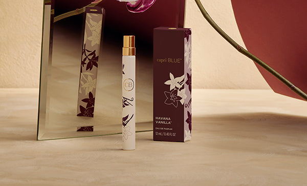 Perfume bottle and packaging on a wooden surface with a blurred background