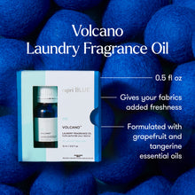 Volcano Laundry Fragrance Oil packaging with blue balls in the background