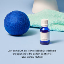 Blue wool ball and bottle with text on a light blue background
