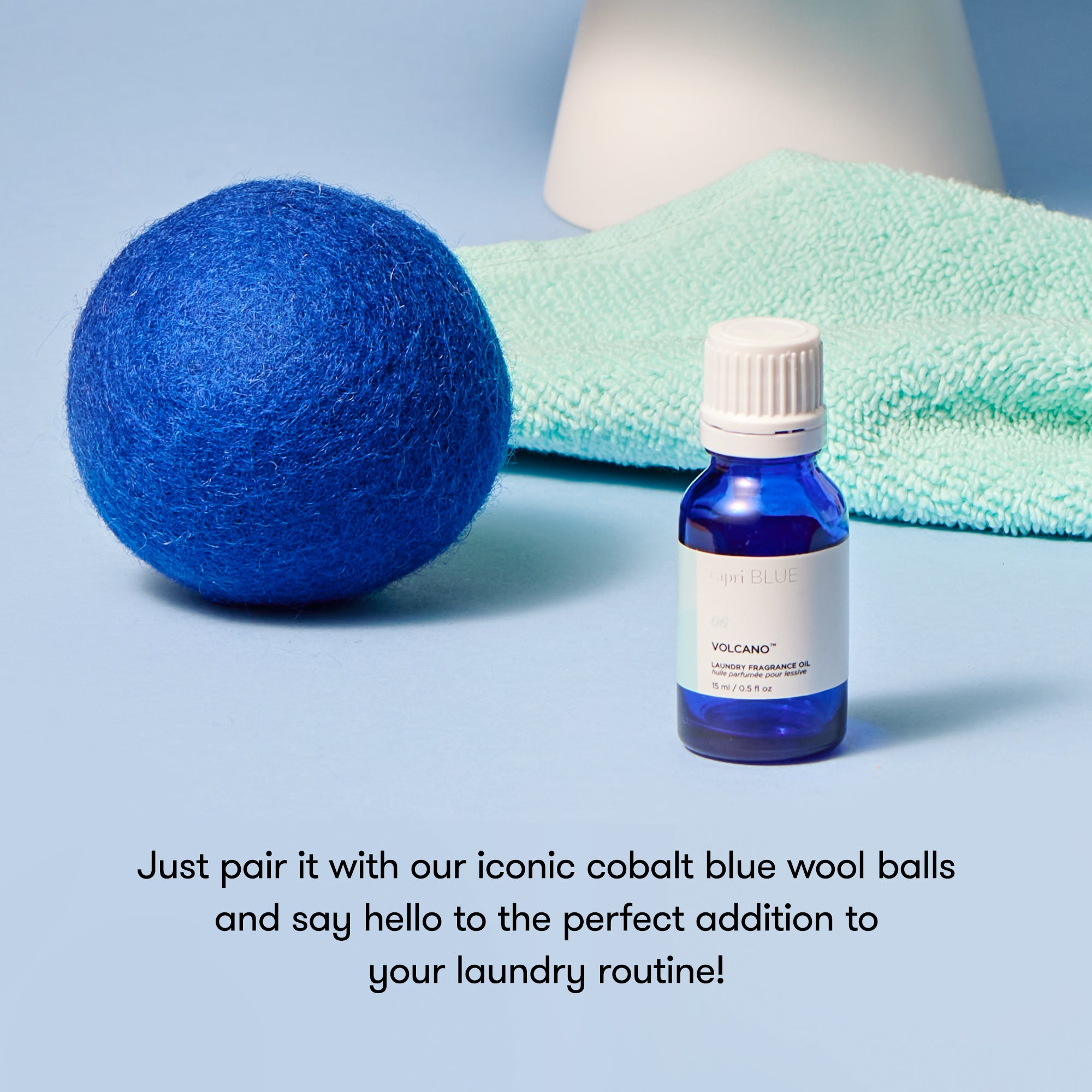 Blue wool ball and bottle with text on a light blue background