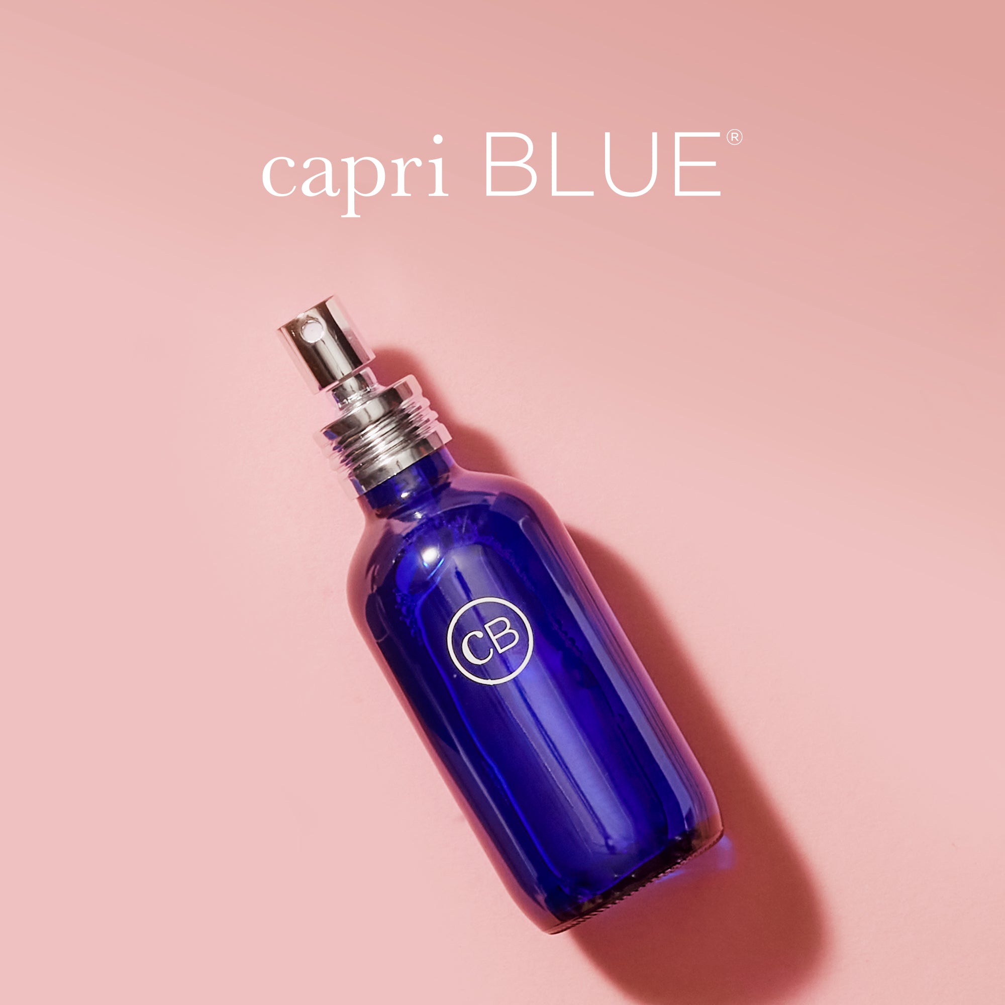 Blue room spray bottle on a pink background with 'capri BLUE'