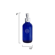 Blue spray bottle with silver nozzle and measurements on a white background