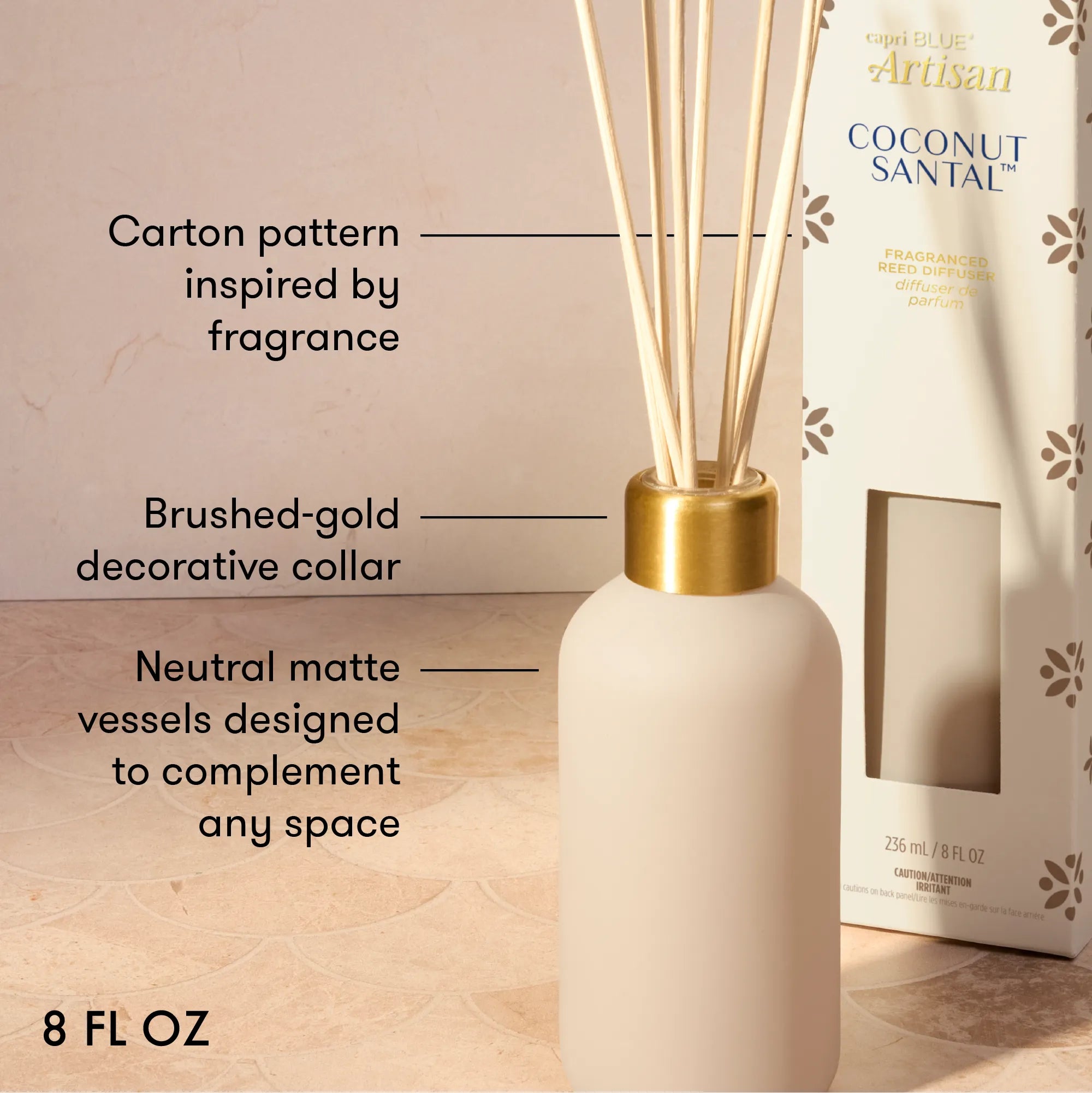 A reed diffuser bottle in a matte cream color with a brushed gold collar and natural reeds, shown next to its branded Coconut Santal box. The image includes text callouts describing the product features.