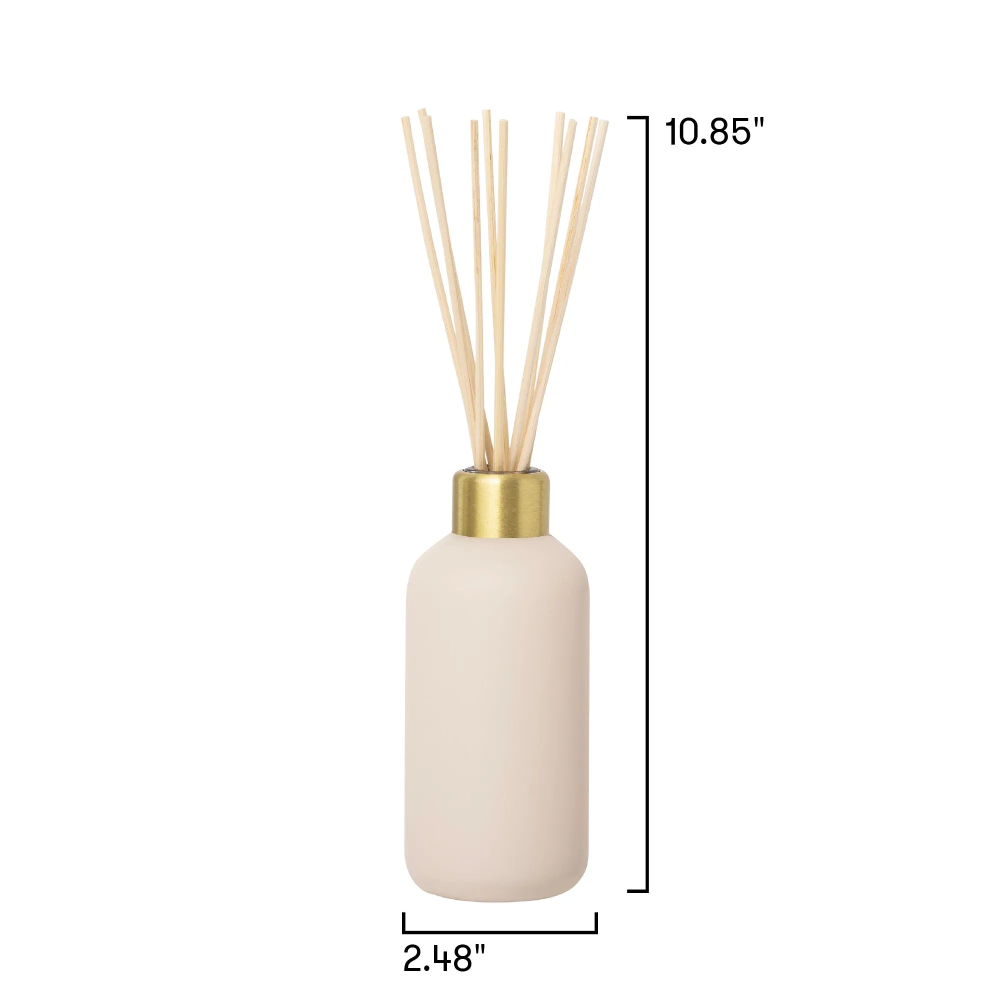 A reed diffuser bottle with a matte cream-colored body, a gold collar, and natural reeds, shown with black dimension lines and text indicating a height of 10.85 inches and a base width of 2.
