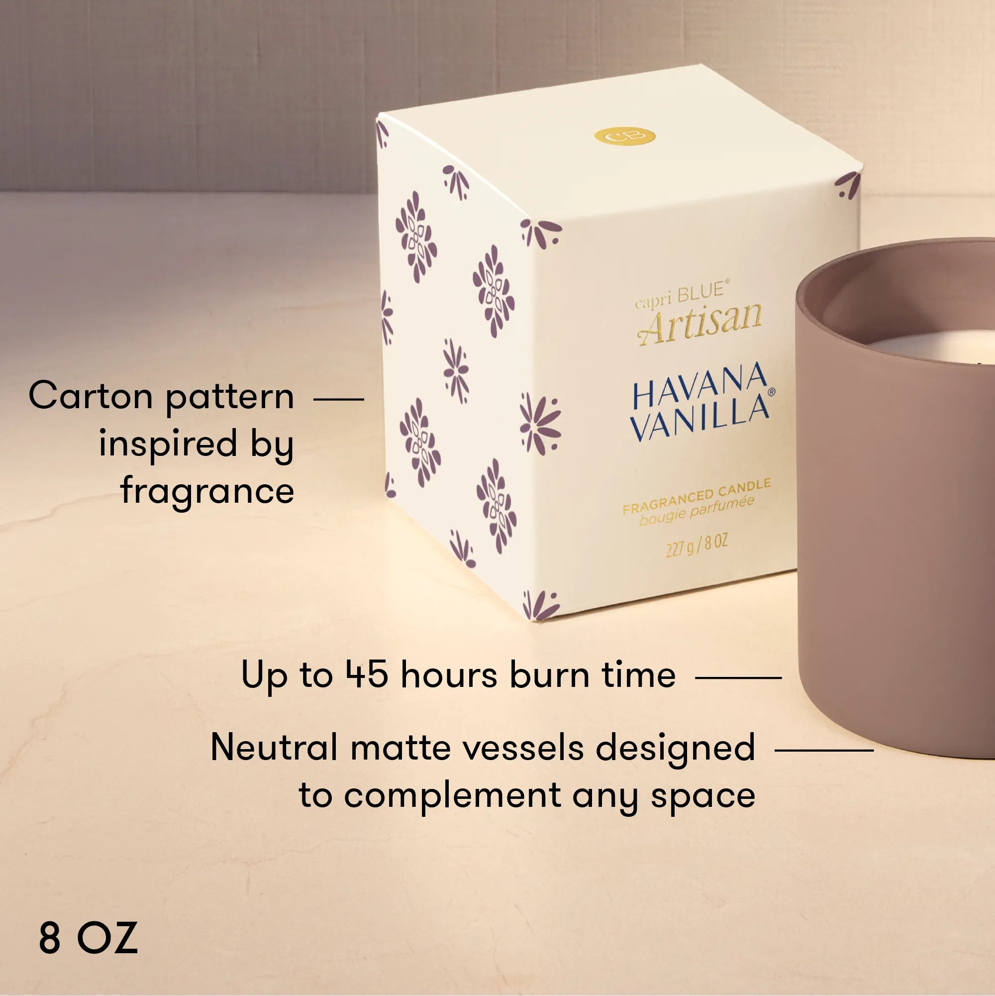 A 8 oz scented candle shown with its white patterned box and a matte taupe candle vessel on a light beige surface. Text on the image highlights the carton design inspiration, up to 45 hours burn time, and neutral matte vessel design.