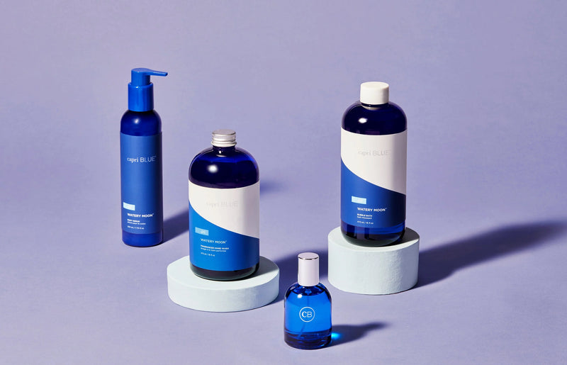 Set of blue skincare products on a gray background