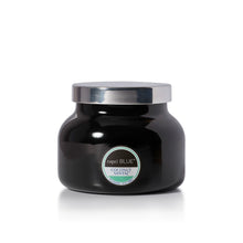 A black glass jar candle with a shiny silver lid and a circular label reading 'capri BLUE' and 'HAVANA VANILLA'.
