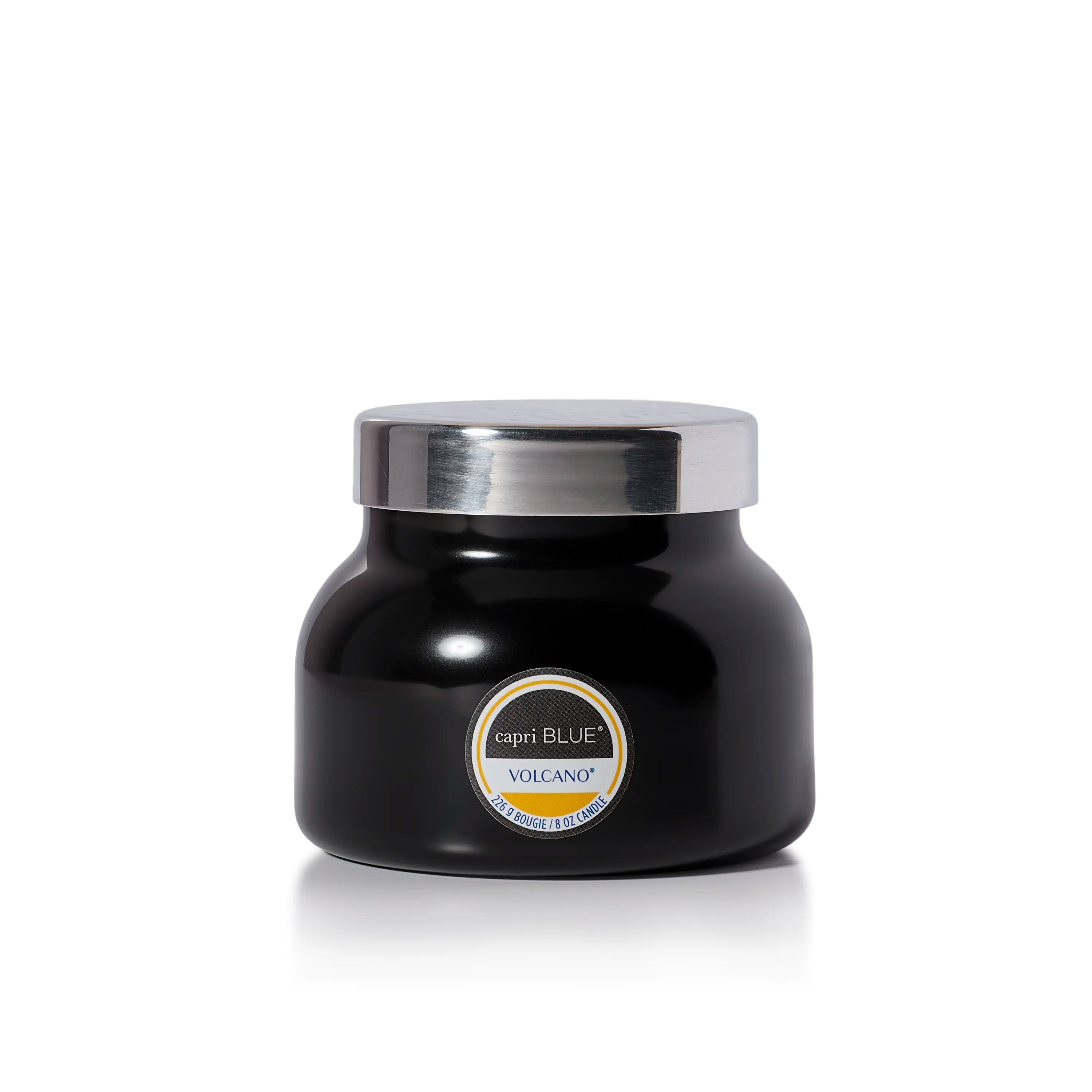 A black jar candle with a shiny silver lid and a circular label reading 'Capri BLUE VOLCANO' on a clean white background.