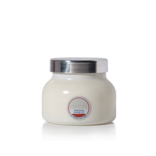 A white jar candle with a metallic silver lid and a circular label reading 'capri BLUE' and 'HAVANA VANILLA'.