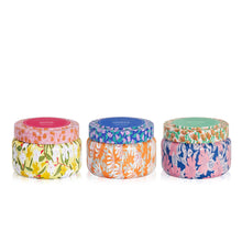 Three colorful jars with floral patterns on lids and bodies against a white background