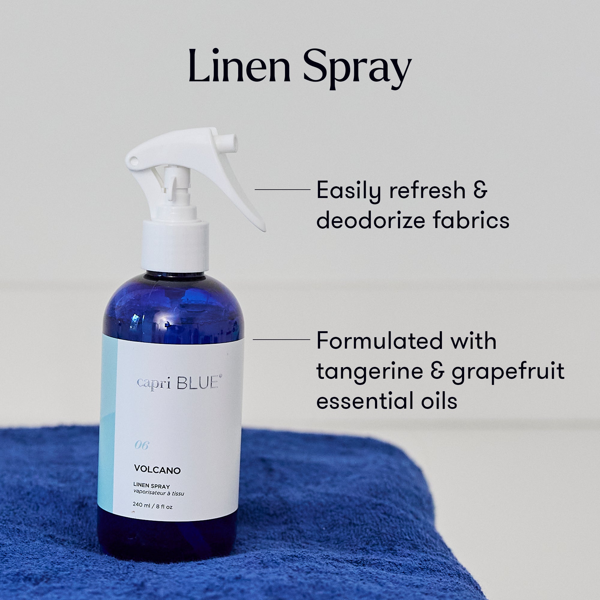 Capri Blue linen spray bottle on a blue towel with text about its uses and ingredients.