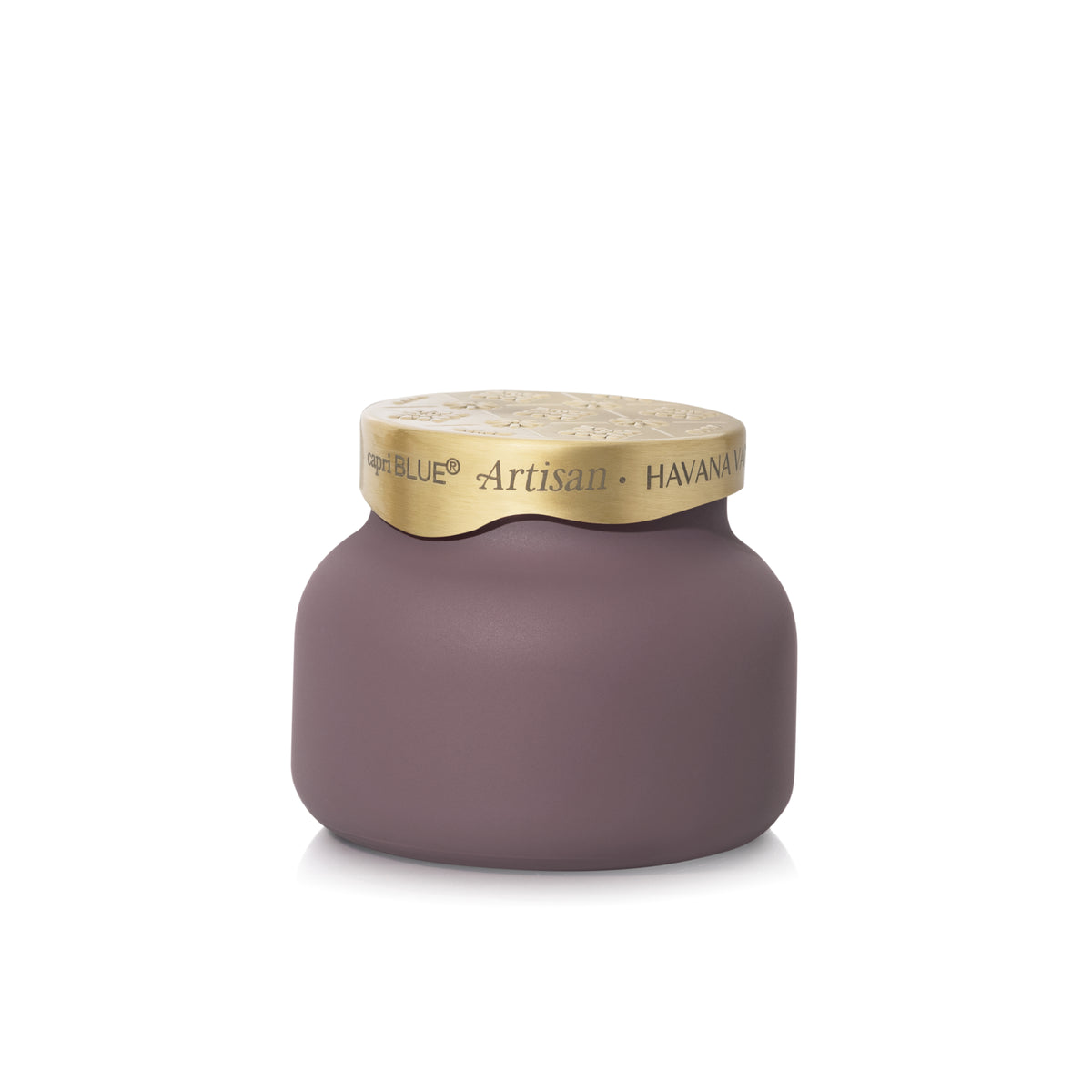 A matte mauve-pink candle jar with a textured gold lid, featuring the brand name 'Capri Blue' and scent name 'Artisan - HAVANA VANILLA' printed on the lid.