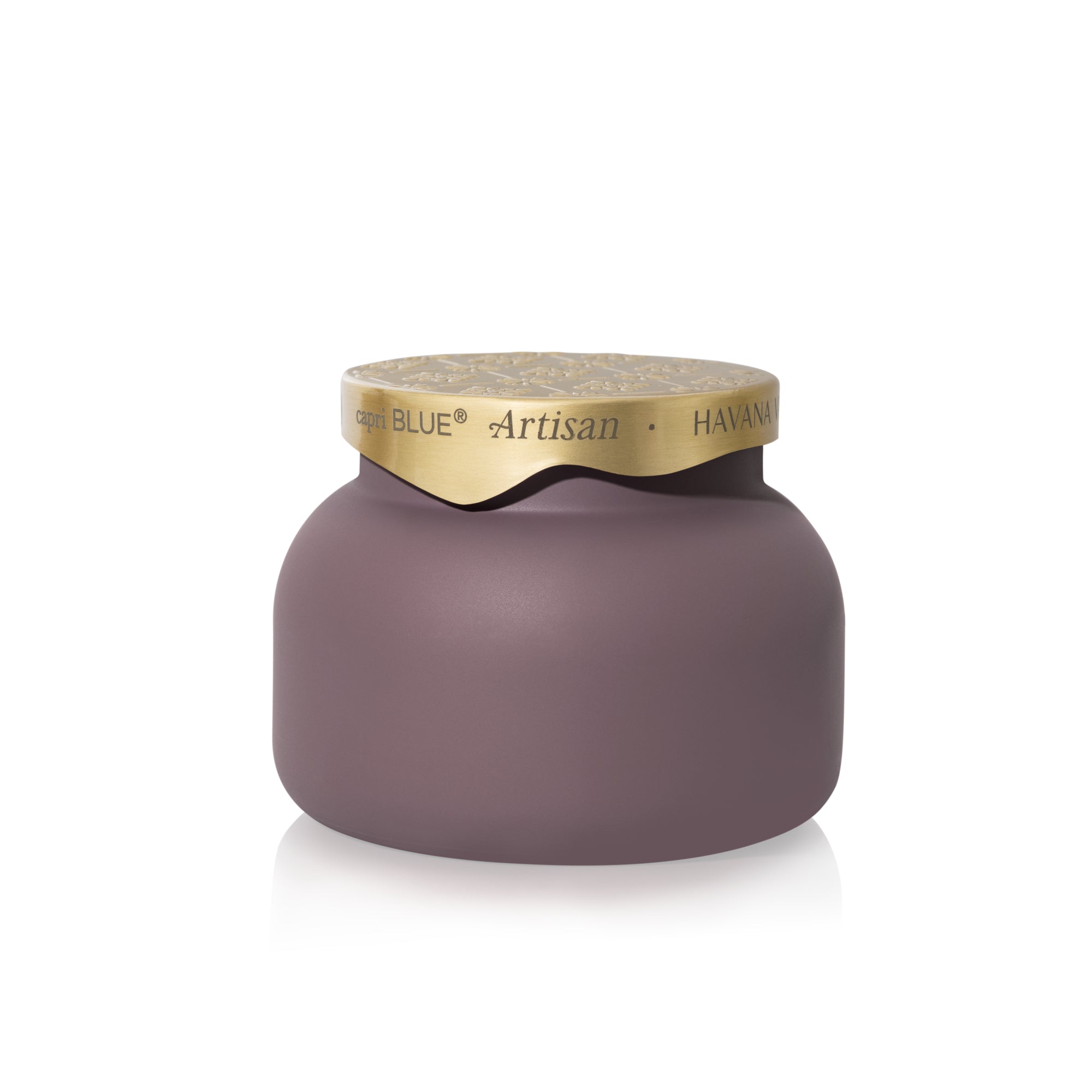 A matte mauve-pink candle jar with a textured gold lid, featuring the brand name 'Capri Blue' and scent name 'Artisan - HAVANA VANILLA' printed on the lid.
